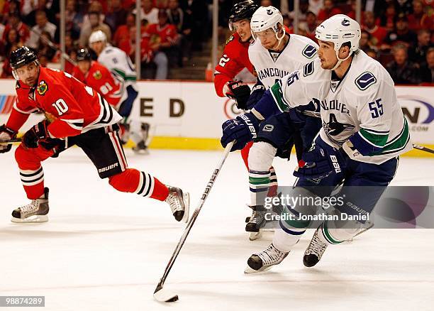 Shane O'Brien of the Vancouver Canucks skates up the ice as Patrick Sharp of the Chicago Blackhawks pursues in Game Two of the Western Conference...