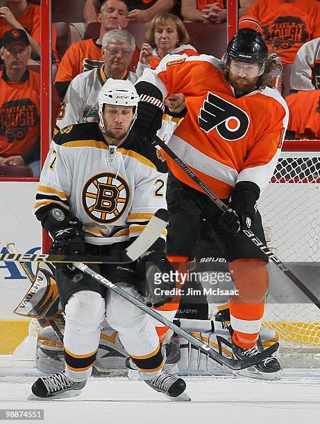 Steve Begin of the Boston Bruins blocks a shot as Scott Hartnell of the Philadelphia Flyers looks on in Game Three of the Eastern Conference...