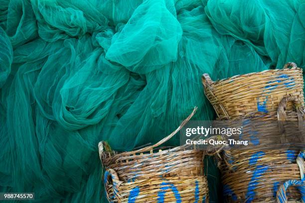 fishing net and baskets in phan rang pier - phan rang stock pictures, royalty-free photos & images