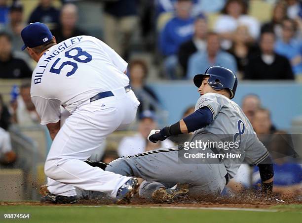 Ryan Braun of the Milwaukee Brewers slides in for a run ahead of the tag by Chad Billingsley of the Los Angeles Dodgers after a wild pitch for a 3-0...
