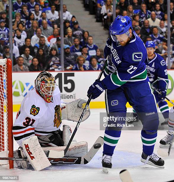 Daniel Sedin of the Vancouver Canucks is stopped by goalie Antti Niemi of the Chicago Blackhawks during the first period in Game Three of the Western...