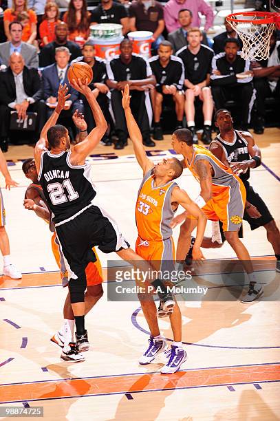 Tim Duncan of the San Antonio Spurs puts a shot up over Grant Hill of the Phoenix Suns in Game Two of the Western Conference Semifinals during the...