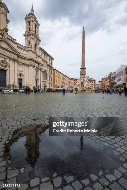 piazza navona with fountain of the four rivers and the egyptian obelisk, rome, lazio, italy, europe - cobblestone puddle stock pictures, royalty-free photos & images