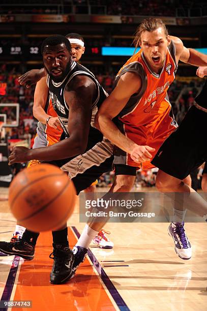 DeJuan Blair of the San Antonio Spurs and Louis Amundson of the Phoenix Suns can only watch a ball go out of bounds in Game Two of the Western...