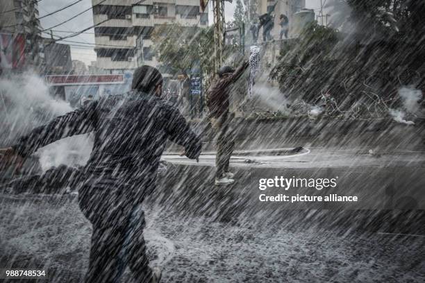 Dpatop - Lebanese security forces fire with a water cannon at Palestinians demonstrating at the United States embassy in Awkar, outside Beirut, 10...