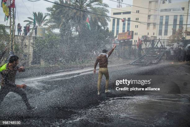 Dpatop - Lebanese security forces fire with a water cannon at Palestinians demonstrating at the United States embassy in Awkar, outside Beirut, 10...