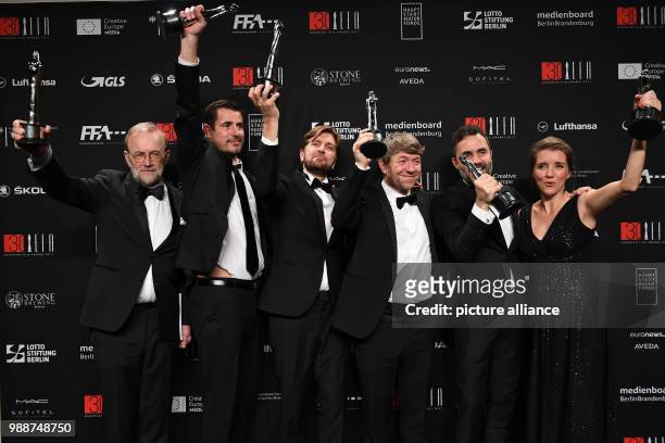 Swedish director Ruben Ostlund , producers Erik Hemmendorf from Sweden and Philippe Bober from France celebrating after receiving the "European Film...