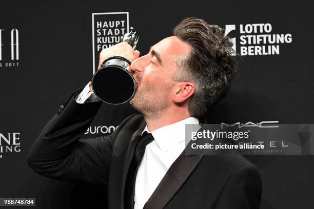 British film director William Oldroyd kissing the prize for the best debut film - which he received for "Lady Macbeth" - during the European Film...