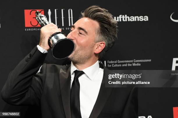 British film director William Oldroyd kissing the prize for the best debut film - which he received for "Lady Macbeth" - during the European Film...