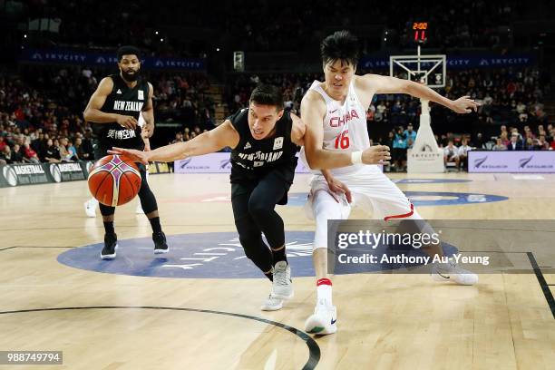 Jarrod Kenny of New Zealand competes the ball against Dong Hanlin of China during the FIBA World Cup Qualifying match between the New Zealand Tall...