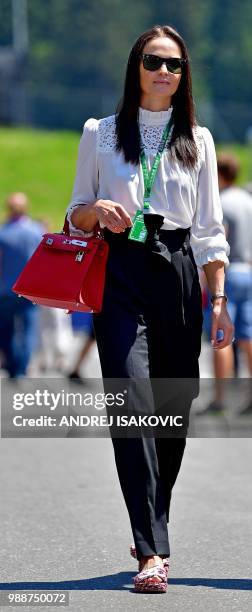 Minttu Virtanen, wife of Ferrari's Finnish driver Kimi Raikkonen, walks down the paddock ahead of the Austrian Formula One Grand Prix in Spielberg,...