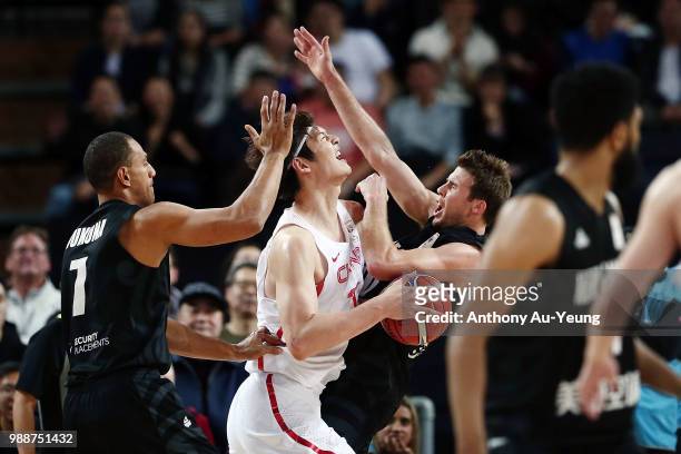 Wang Zhelin of China clashes with Tom Abercrombie of New Zealand during the FIBA World Cup Qualifying match between the New Zealand Tall Blacks and...