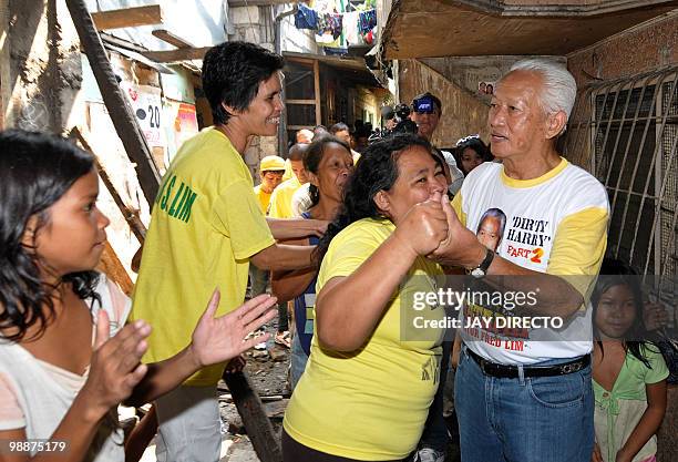 By Jason Gutierrez Manila Mayor Alfredo Lim shakes hands with residents in a crowded slum area as he campaigns for re-election in Manila on April 5,...