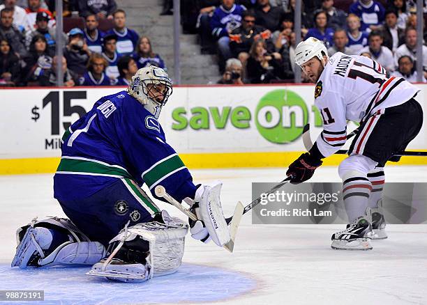 Goalie Roberto Luongo of the Vancouver Canucks watches the shot of John Madden of the Chicago Blackhawks go wide of the net during the second period...