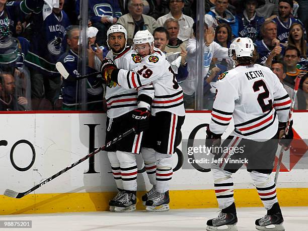 Jonathan Toews and Duncan Keith of the Chicago Blackhawks celebrate the goal scored by teammate Dustin Byfuglien in Game Three of the Western...