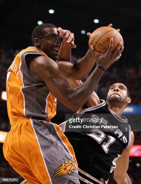 Amar'e Stoudemire of the Phoenix Suns is fouled by Tim Duncan of the San Antonio Spurs as he attempts a shot during Game Two of the Western...