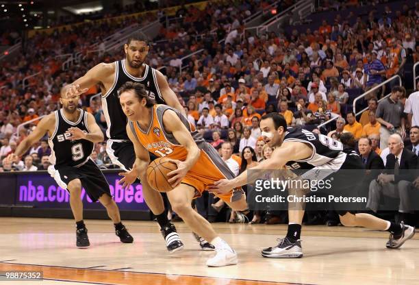 Steve Nash of the Phoenix Suns drives the ball past Tony Parker, Tim Duncan and Manu Ginobili of the San Antonio Spurs during Game Two of the Western...