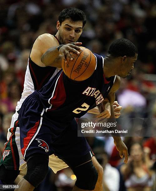 Joe Johnson of the Atlanta Hawks is pressured by Carlos Delfino of the Milwaukee Bucks in Game Six of the Eastern Conference Quarterfinals during the...