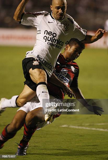 Roberto Carlos of Corinthians fights for the ball with player of Flamengo during their Libertadores Cup match at Pacaembu stadium on May 5, 2010 in...