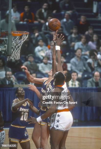 Clark Kellogg of the Indiana Pacers battles for a rebound with Rick Mahorn of the Washington Bullets during an NBA basketball game circa 1984 at the...