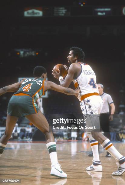 Cliff Robinson of the Washington Bullets looks to pass the ball over Sidney Moncrief of the Milwaukee Bucks during an NBA basketball game circa 1985...