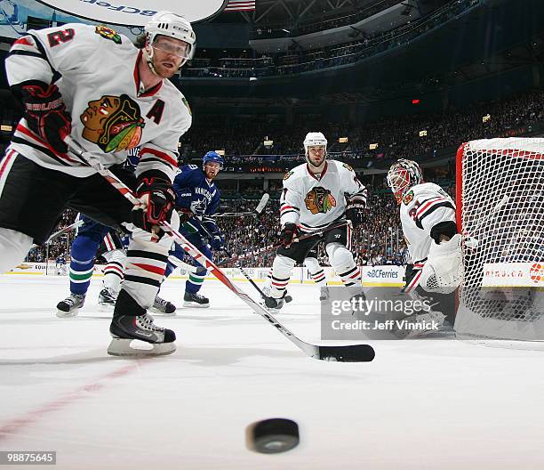 Duncan Keith of the Chicago Blackhawks moves the puck away from the net against the Vancouver Canucks in the second period in Game Three of the...