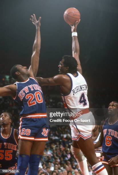 Cliff Robinson of the Washington Bullets shoots over James Bailey of the New York Knicks during an NBA basketball game circa 1986 at the Capital...