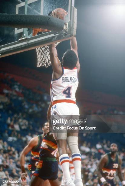 Cliff Robinson of the Washington Bullets goes up for a slam dunk against the Denver Nuggets during an NBA basketball game circa 1986 at the Capital...