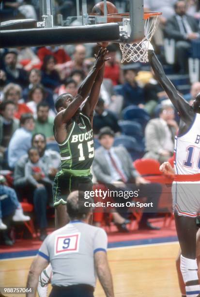 Craig Hodges of the Milwaukee Bucks shoots over Manute Bol of the Washington Bullets during an NBA basketball game circa 1985 at the Capital Centre...