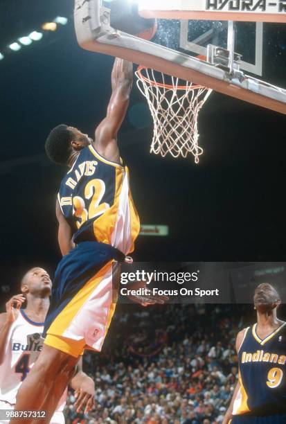 Dale Davis of the Indiana Pacers slam dunks against the Washington Bullets during an NBA basketball game circa 1995 at the US Airways Arena in...