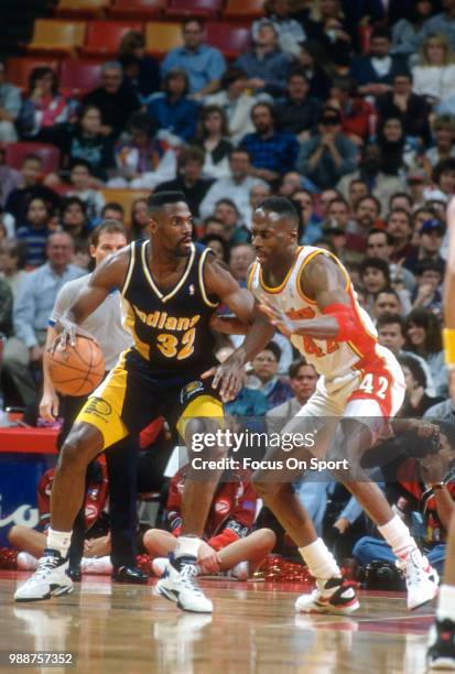 Dale Davis of the Indiana Pacers backs in on Kevin Willis of the Atlanta Hawks during an NBA basketball game circa 1994 at the Omni Coliseum in...