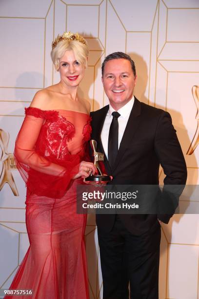 Kate Peck and Matt White from Chanel 10 pose with the award for most outstanding sport coverage at the 60th Annual Logie Awards at The Star Gold...