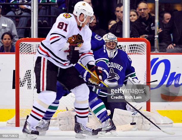 Goalie Roberto Luongo of the Vancouver Canucks makes a save after Marian Hossa of the Chicago Blackhawks re-directed the puck during the third period...