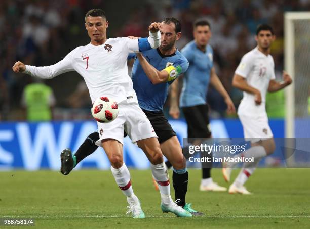 Cristiano Ronaldo of Portugal vies with Diego Godin of Uruguay during the 2018 FIFA World Cup Russia Round of 16 match between Uruguay and Portugal...