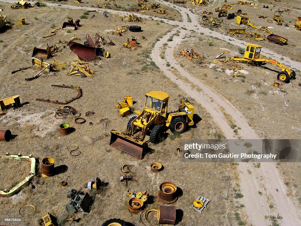 Front-end loader in heavy equipment salvage yard