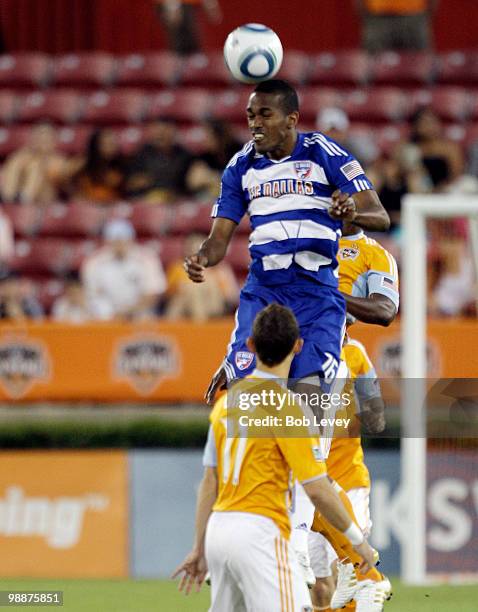 Atiba Harris of FC Dallas goes up high for a header in front of Brad Davis of the Houston Dynamo at Robertson Stadium on May 5, 2010 in Houston,...