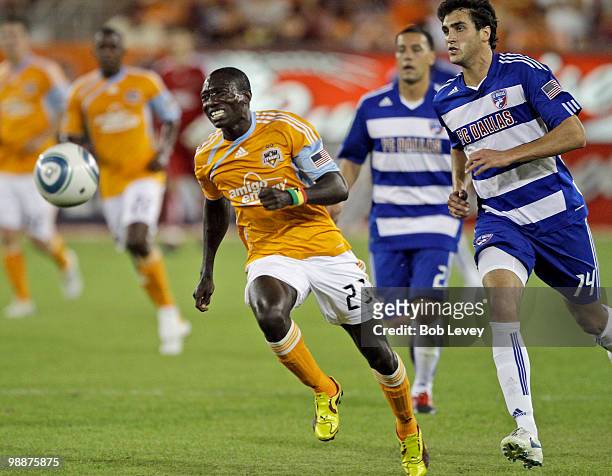 Dominic Oduro of the Houston Dynamo tries to catch up with the ball as George John of FC Dallas pursues at Robertson Stadium on May 5, 2010 in...