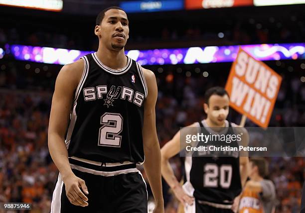 Garrett Temple and Manu Ginobili of the San Antonio Spurs walk off the court after being defeated by the Phoenix Suns during Game Two of the Western...