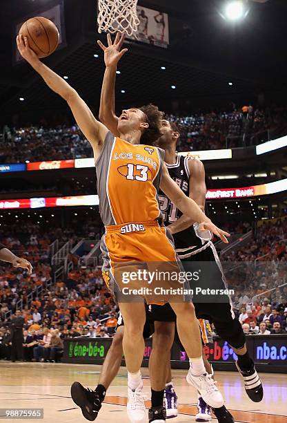 Steve Nash of the Phoenix Suns lays up a shot past Tim Duncan of the San Antonio Spurs during Game Two of the Western Conference Semifinals of the...