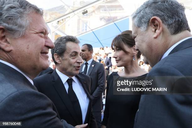 Former French President Nicolas Sarkozy and his wife Carla Bruni talk with the sons of late French politician and Holocaust survivor Simone Veil,...