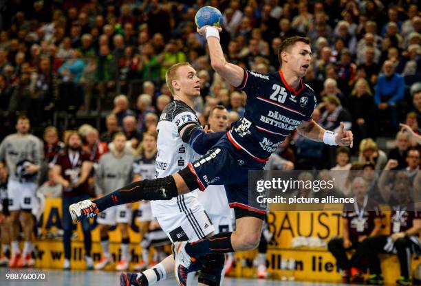 Flensburg's Rasmus Lauge breaking through the defence of Kiel's Rene Toft-Hansen during the German Bundesliga handball match between SG...