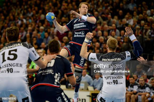 Flensburg's Simon Jeppson attempting to defeat Kiel's defence during the German Bundesliga handball match between SG Flensburg-Handewitt and THW Kiel...