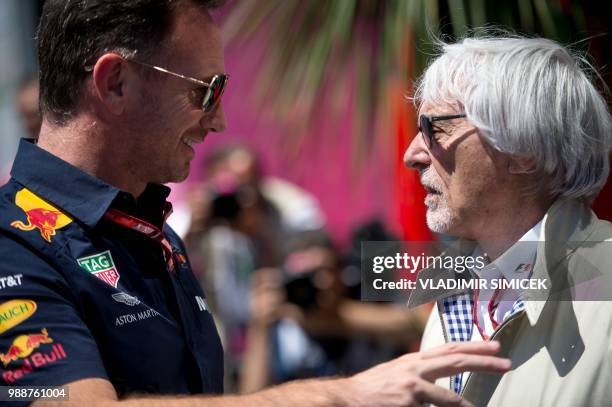 Red Bull team principal Christian Horner talks to former F1 boss Bernie Ecclestone in the paddock ahead of the Austrian Formula One Grand Prix in...