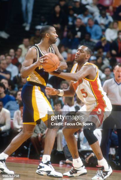 Danny Manning of the Atlanta Hawks closely guards Derrick McKey of the Indiana Pacers during an NBA basketball game circa 1994 at the Omni Coliseum...