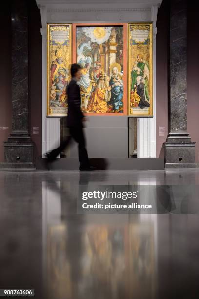 Woman waling past the former high alterpiece of St. Martin in Messkirch, at the exhibition "The Master of Messkirch - Catholic Splendour during the...