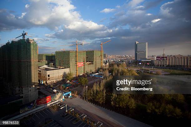 Buildings surround Yinhe Square in Baotou, Inner Mongolia, China, on Wednesday, May 5, 2010. China's home prices may slump 30 percent as local...