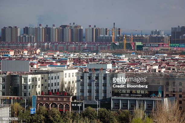 Residential and commercial buildings rise up in the skyline of Baotou, Inner Mongolia, China, on Wednesday, May 5, 2010. China's home prices may...