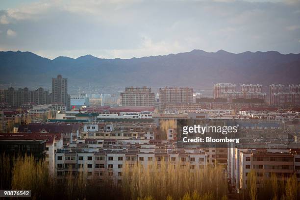 Residential and commercial buildings rise up in the skyline of Baotou, Inner Mongolia, China, on Wednesday, May 5, 2010. China's home prices may...