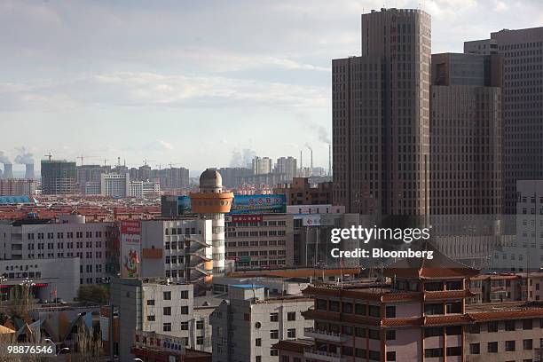 Residential and commercial buildings rise up in the skyline of Baotou, Inner Mongolia, China, on Wednesday, May 5, 2010. China's home prices may...