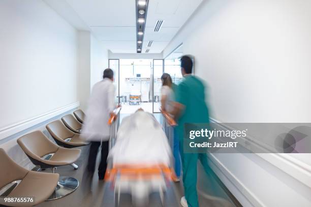 doctor wheeling patient - wheeling imagens e fotografias de stock